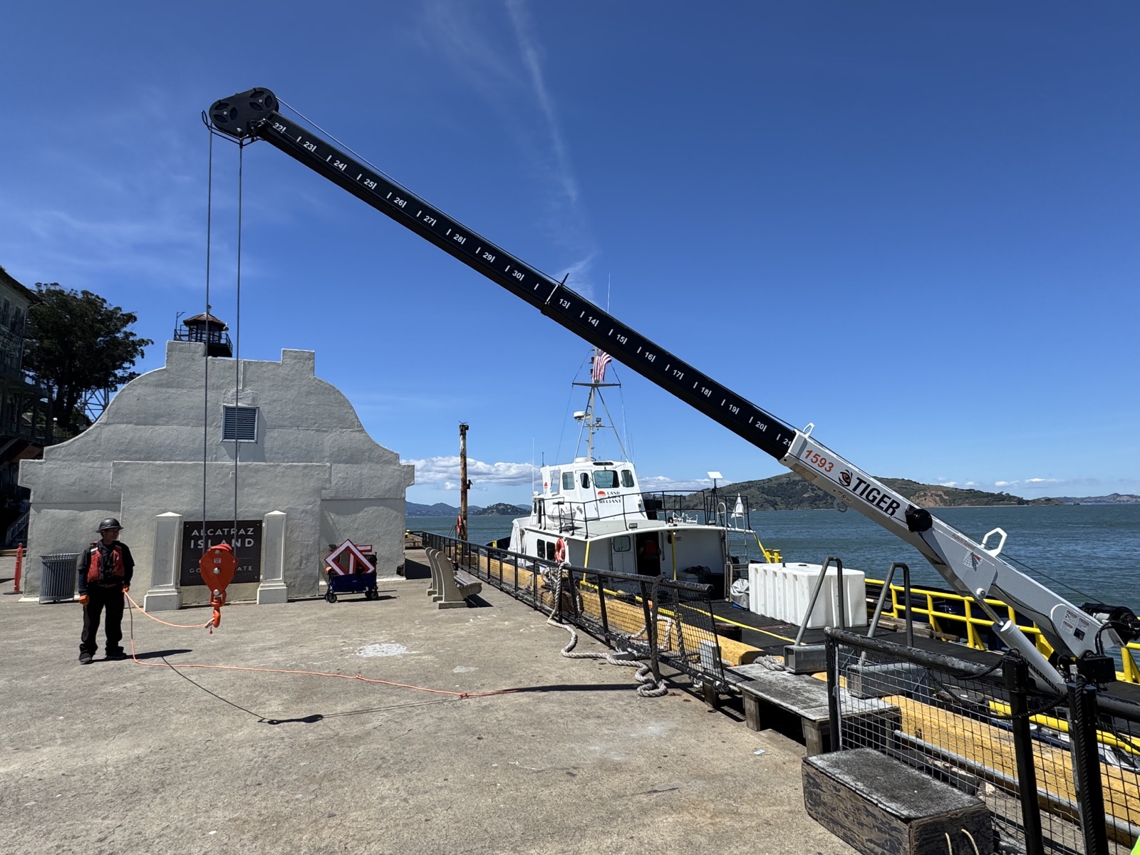 M/V Land & Sea Reliant alongside the dock with its crane extended